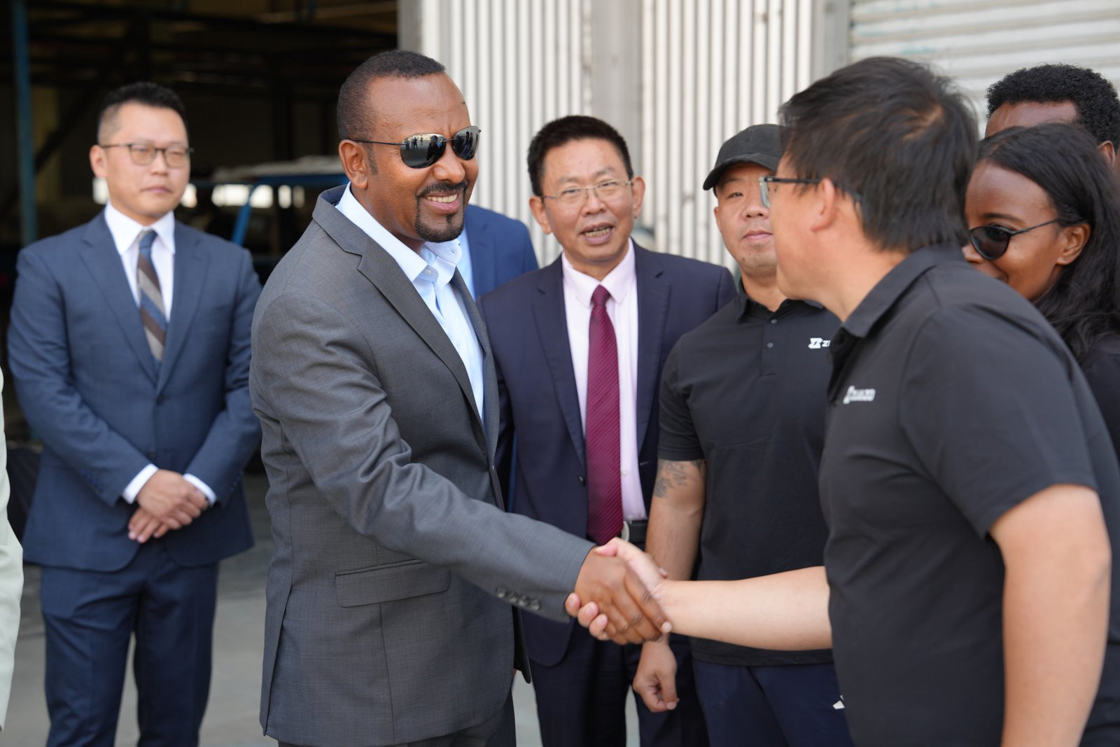 Ethiopian Prime Minister Abiy Ahmed shakes hands with ZIJAZO team members at the factory